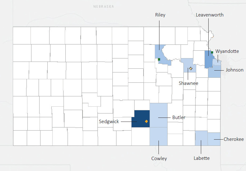 Map presenting top defense contract spending locations within the state of Kansas with an overlay showing the positions of key military installations differentiated by service and active/reserve affiliation.