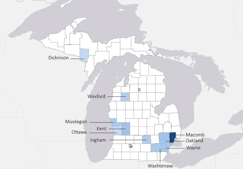 Map presenting top defense contract spending locations within the state of Michigan with an overlay showing the positions of key military installations differentiated by service and active/reserve affiliation.