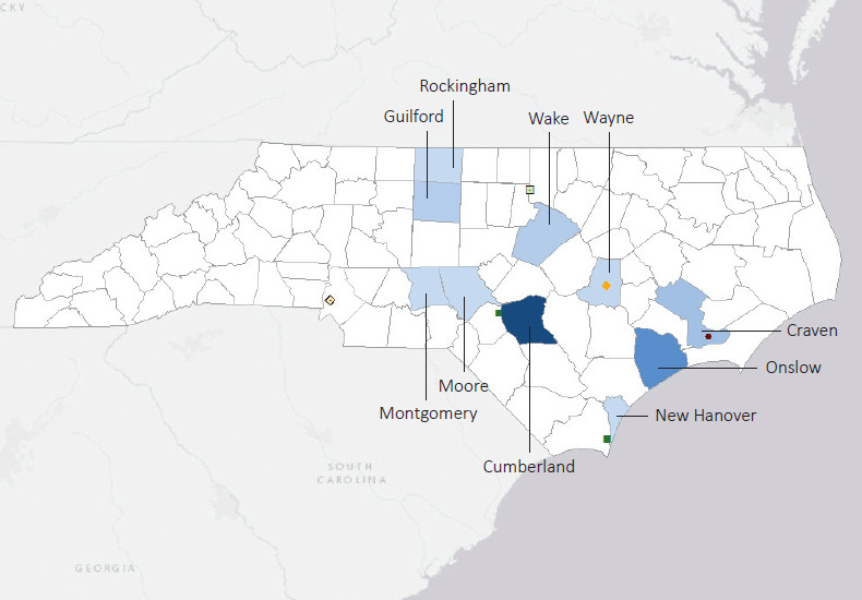 Map presenting top defense contract spending locations within the state of North Carolina with an overlay showing the positions of key military installations differentiated by service and active/reserve affiliation.