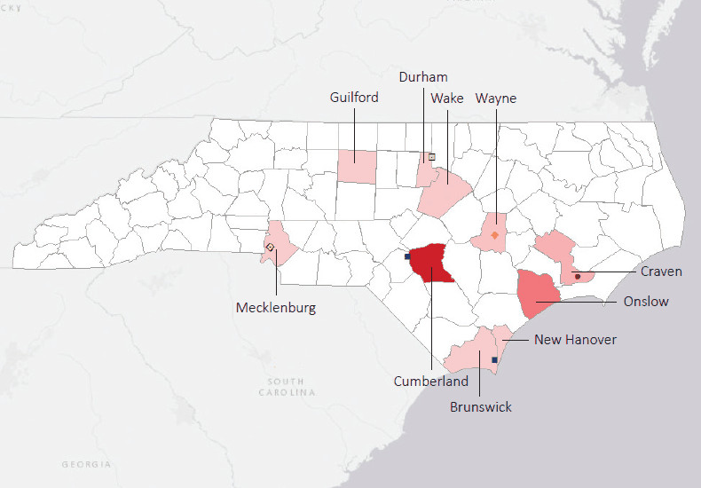 Map presenting top defense personnel spending locations within the state of North Carolina with an overlay showing the positions of key military installations differentiated by service and active/reserve affiliation.
