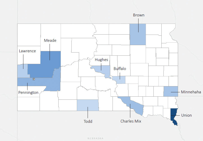 Map presenting top defense contract spending locations within the state of South Dakota with an overlay showing the positions of key military installations differentiated by service and active/reserve affiliation.